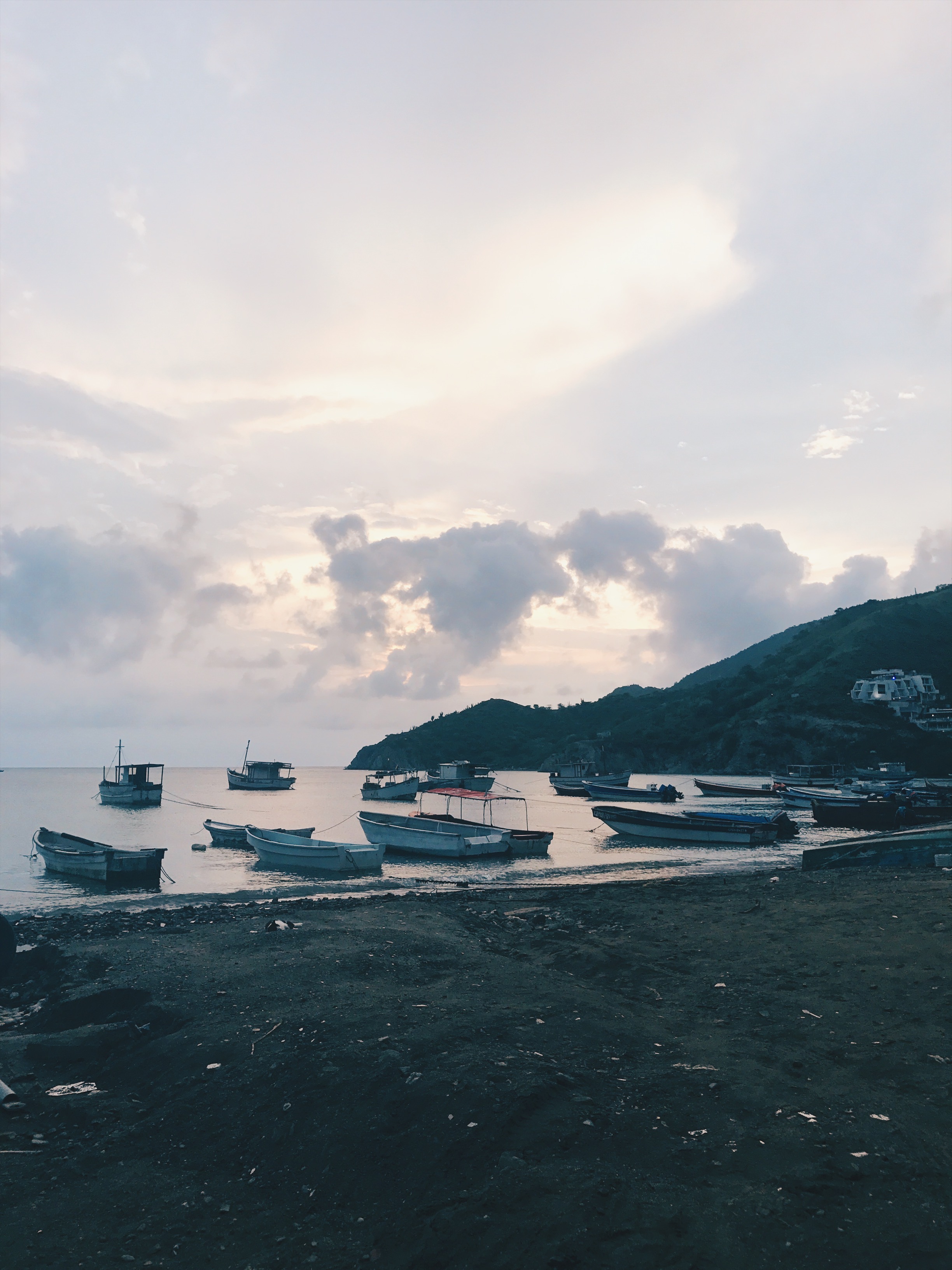 Boats by the beach and cloudy sky